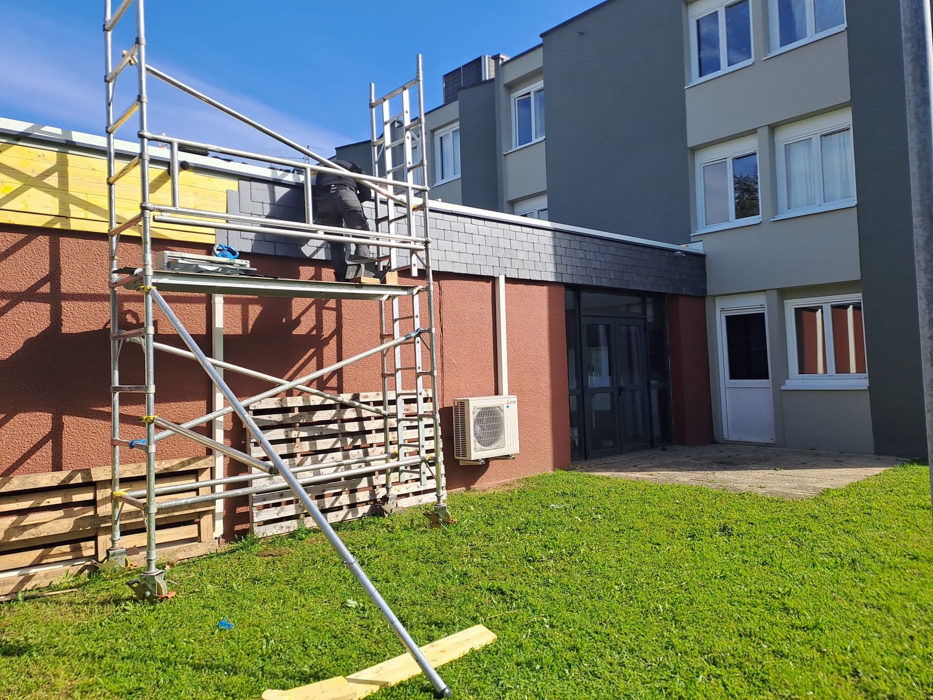 Pose d'ardoises sur bâtiment collectif avec échafaudage